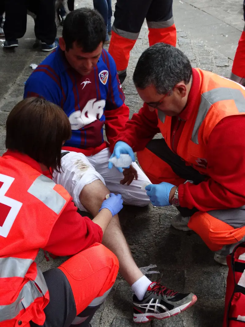 Voluntarios sanitarios atienden a un corredor herido tras el encierro (2014).